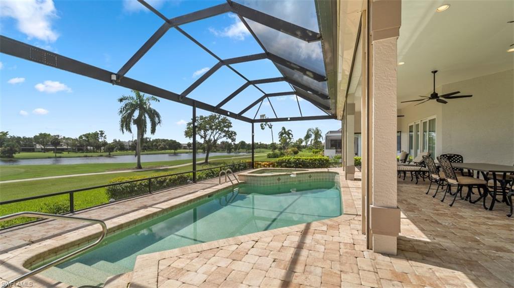 Image 3: Screened lanai featuring a swimming pool, integrated spa, and paver patio