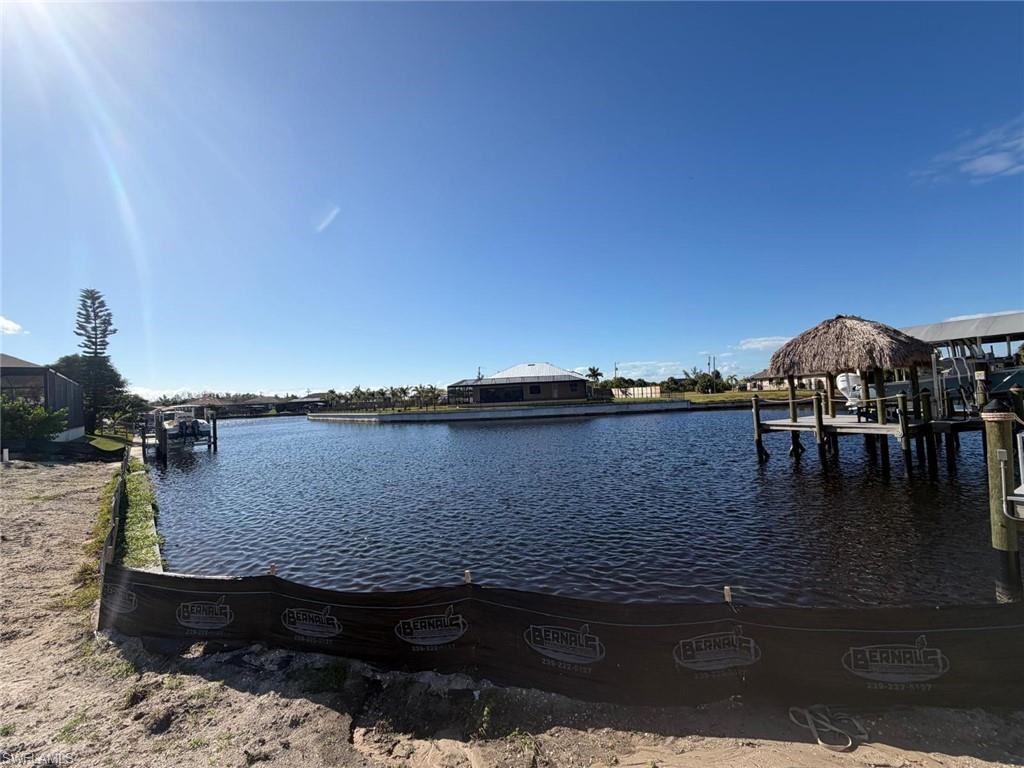 Image 4: Dock featuring a water view and boat lift