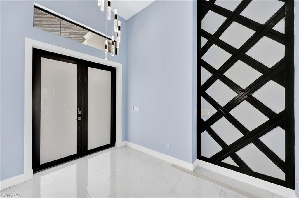 Image 3: Foyer entrance with french doors and baseboards