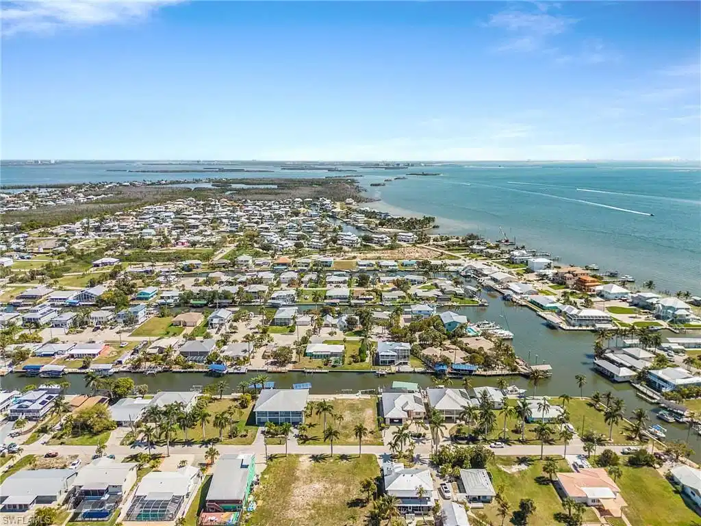Image 1: Aerial perspective of suburban area featuring a large body of water