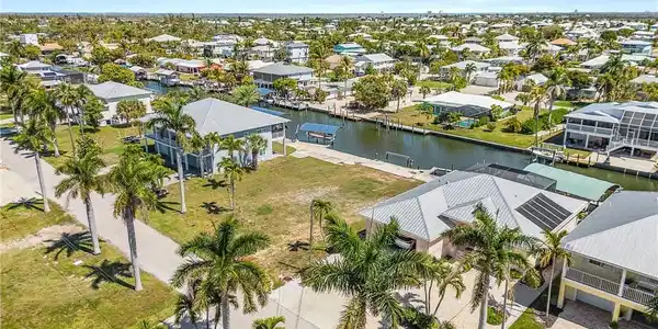 Image 4: Aerial view of residential area with a large body of water