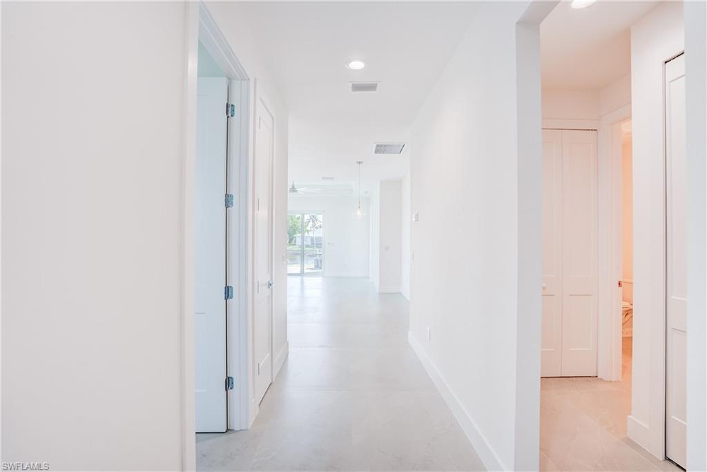 Image 4: Corridor with baseboards and recessed lighting