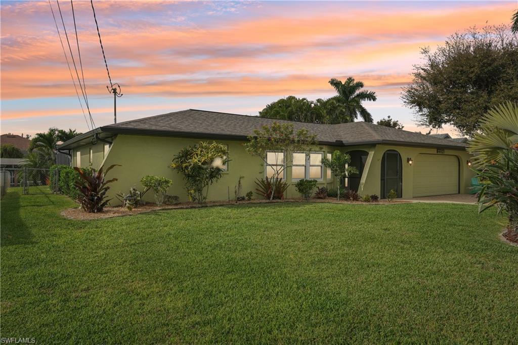 Image 2: Single story home with stucco siding, a garage, a front yard, and a shingled roof