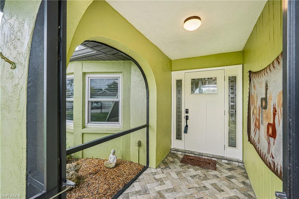 Image 4: Property entrance with stucco siding