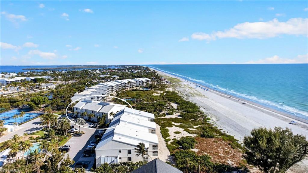 Image 4: Coastal residential buildings situated along a sandy beachfront