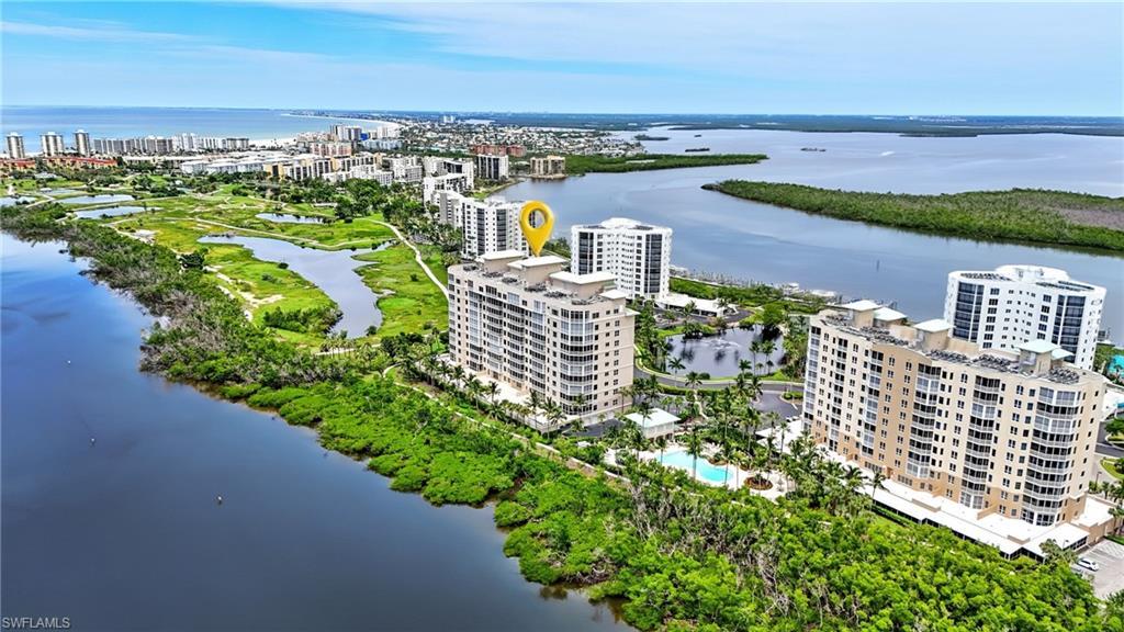 Image 2: View of urban area with apartment complex / building and a large body of water - Virtually Edited Image