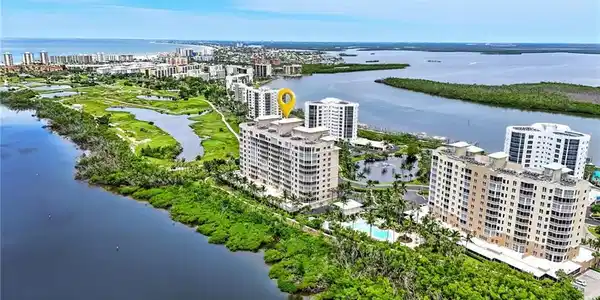 Image 2: View of urban area with apartment complex / building and a large body of water - Virtually Edited Image