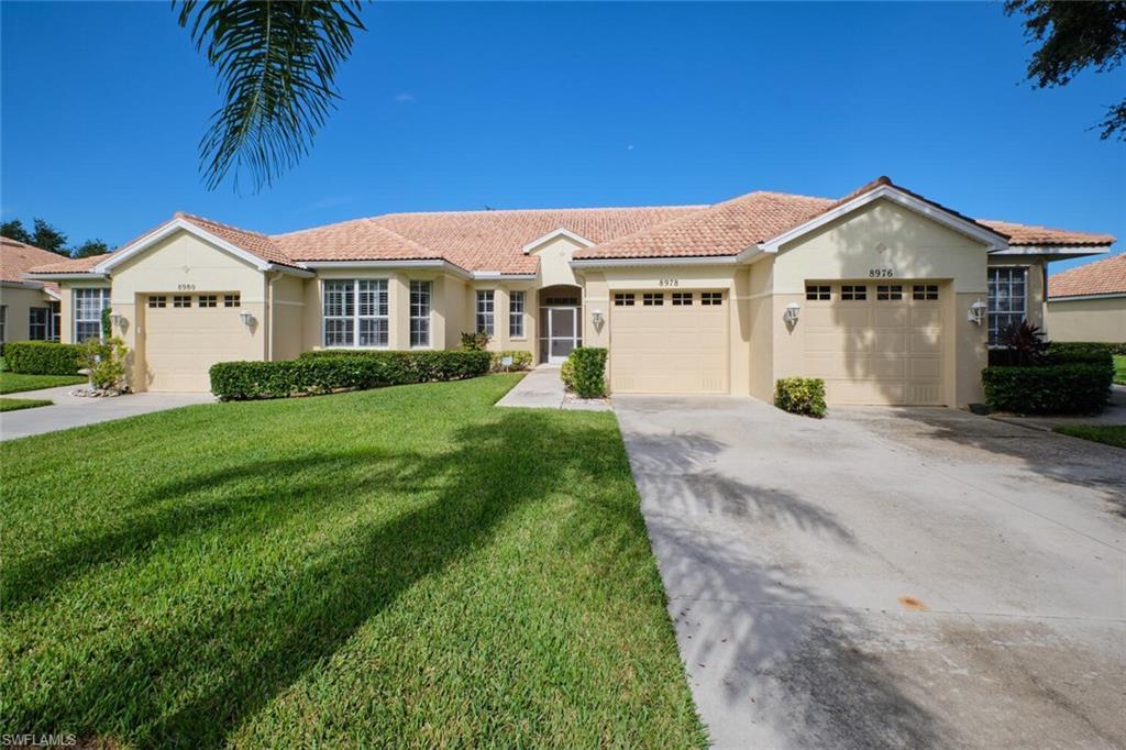 Image 1: View of front facade with a front lawn and a garage