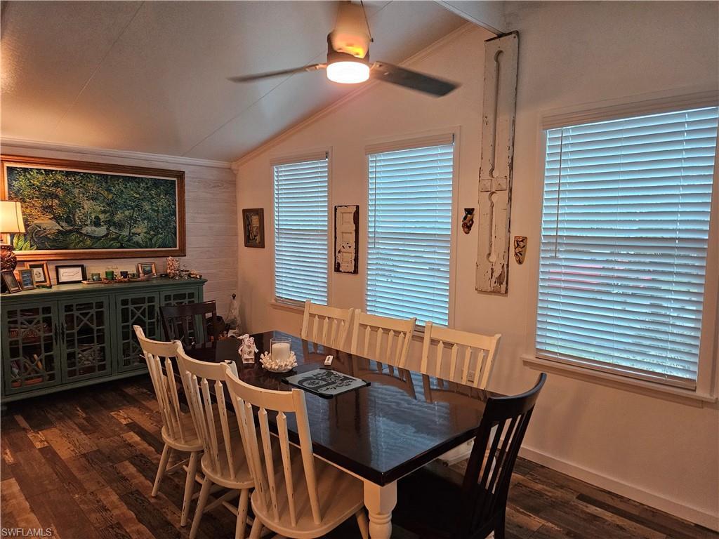 Image 3: Dining space with lofted ceiling, crown molding, dark hardwood / wood-style floors, and ceiling fan
