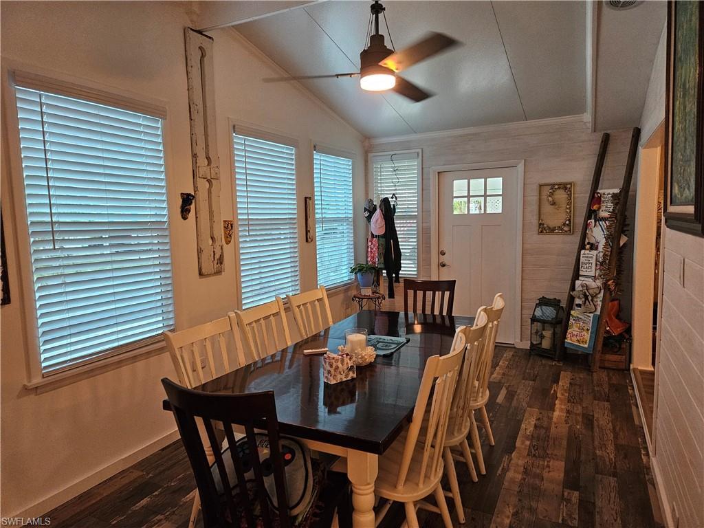 Image 4: Dining space with dark wood-type flooring, ornamental molding, ceiling fan, and vaulted ceiling