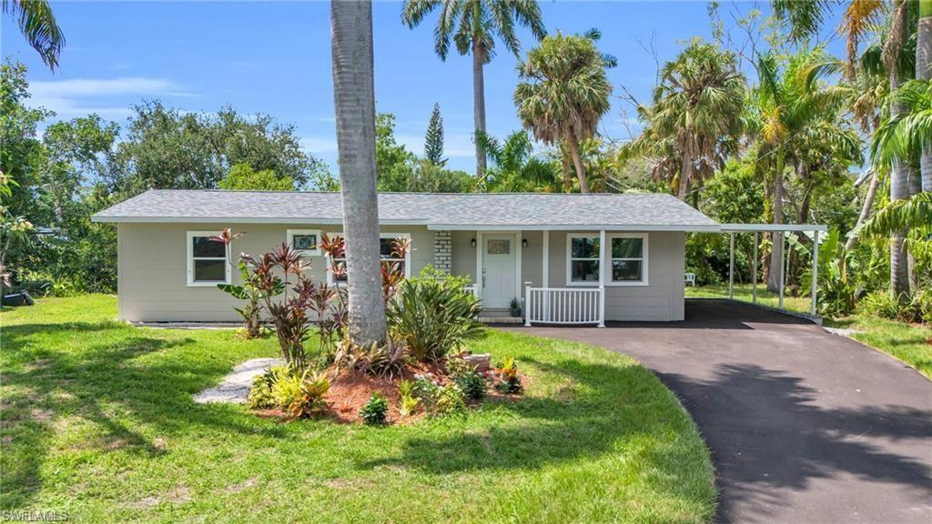 Image 1: Ranch-style home with aphalt driveway, a front lawn, a shingled roof, a carport, and a porch