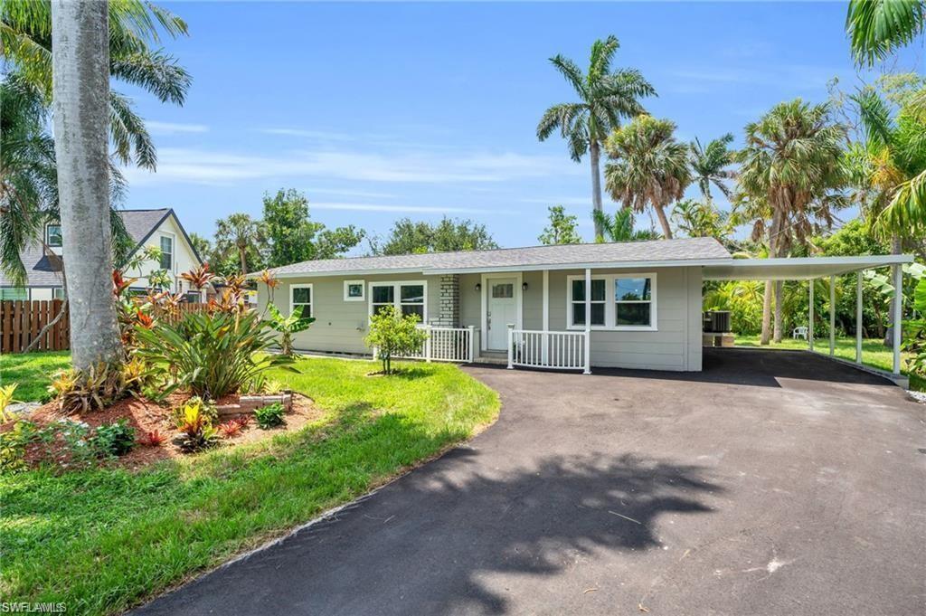 Image 2: Single story home featuring driveway, an attached carport, fence, a front lawn, and a porch