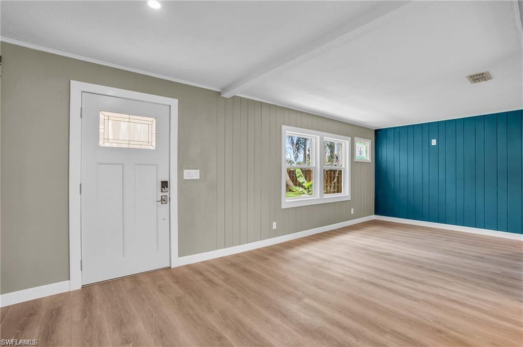 Image 3: Foyer with visible vents, baseboards, beamed ceiling, and wood finished floors
