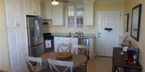 Image 3: Kitchen with ceiling fan, ornamental molding, white cabinetry, stainless steel refrigerator with ice dispenser, and black stove