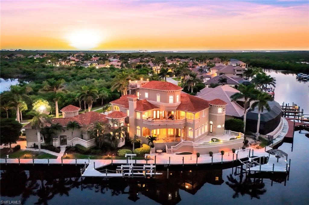 Image 1: This 3 story Estate, crafted by renowned luxury builder PGI Homes, is built to commercial standards with concrete floors and walls, impact-rated doors and windows, a whole-home fire suppression system, and a private elevator serving all three levels.