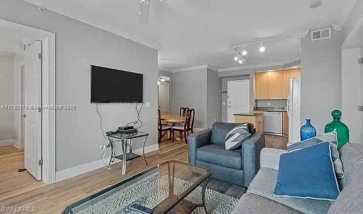Image 2: Bedroom featuring crown molding, light wood finished floors, and ceiling fan