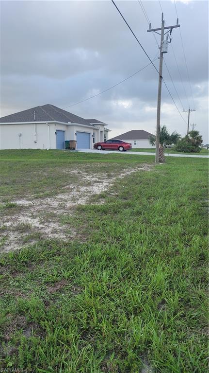Image 4: View of green lawn featuring an attached garage