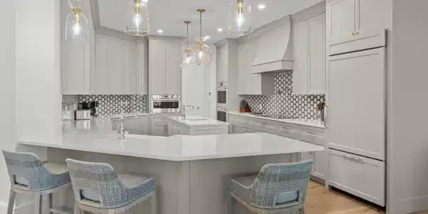 Image 3: Kitchen featuring a peninsula, a breakfast bar area, light stone countertops, hanging light fixtures, and recessed lighting