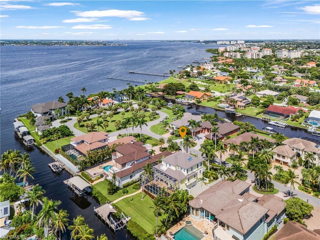 Image 2: Aerial view of residential area featuring a large body of water