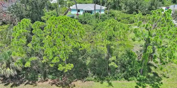 Image 4: Aerial view of property and surrounding area featuring a forest