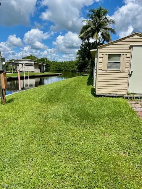 Image 4: View of grassy yard featuring a water view and a shed
