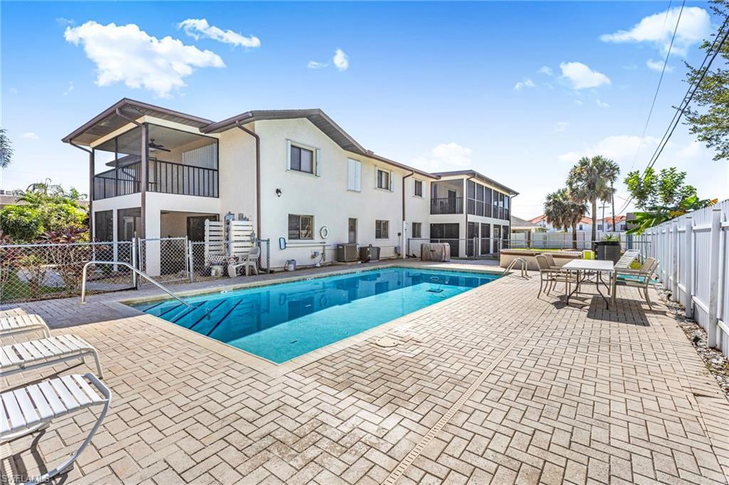 Image 4: Community pool featuring a patio, a fenced backyard, a balcony, and a ceiling fan