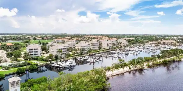 Image 4: Drone / aerial view of numerous boat docks and a nearby body of water