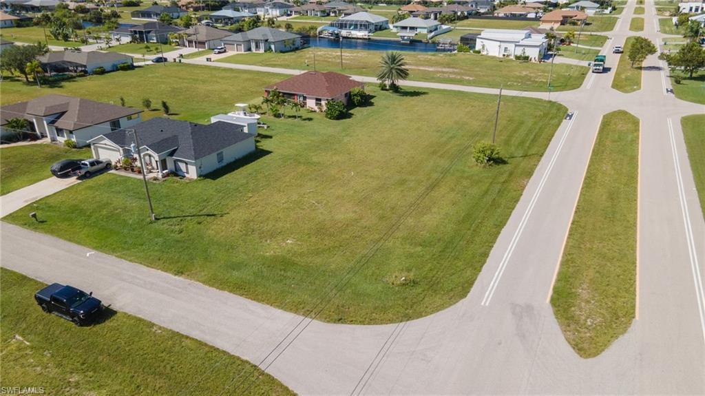 Image 1: Aerial perspective of suburban area with a nearby body of water