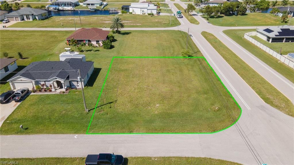 Image 2: Aerial view of residential area with property boundaries highlighted and a nearby body of water