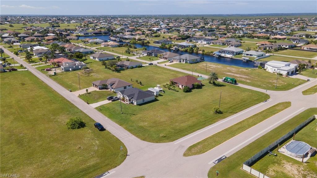 Image 3: Aerial perspective of suburban area featuring a large body of water