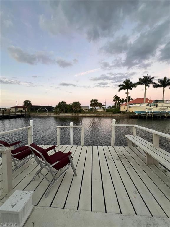 Image 3: Dock featuring a water view