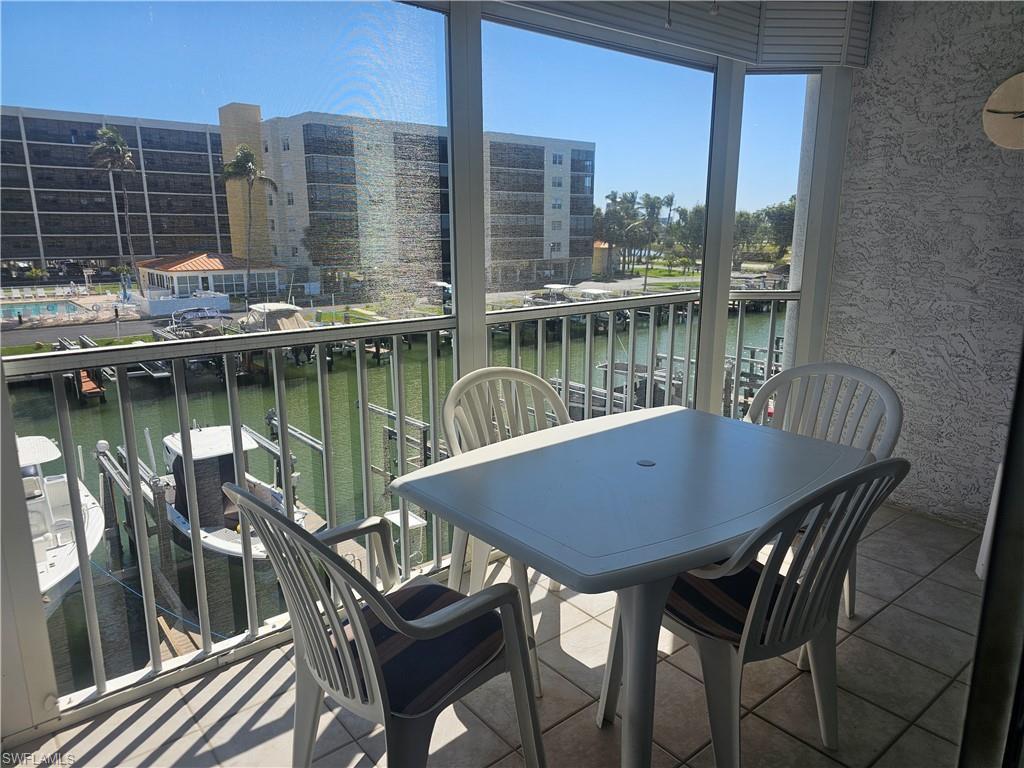 Image 2: Balcony with a sunroom and a water view