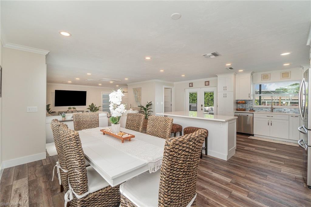 Image 3: Dining area with recessed lighting, crown molding, dark wood-style flooring, and french doors