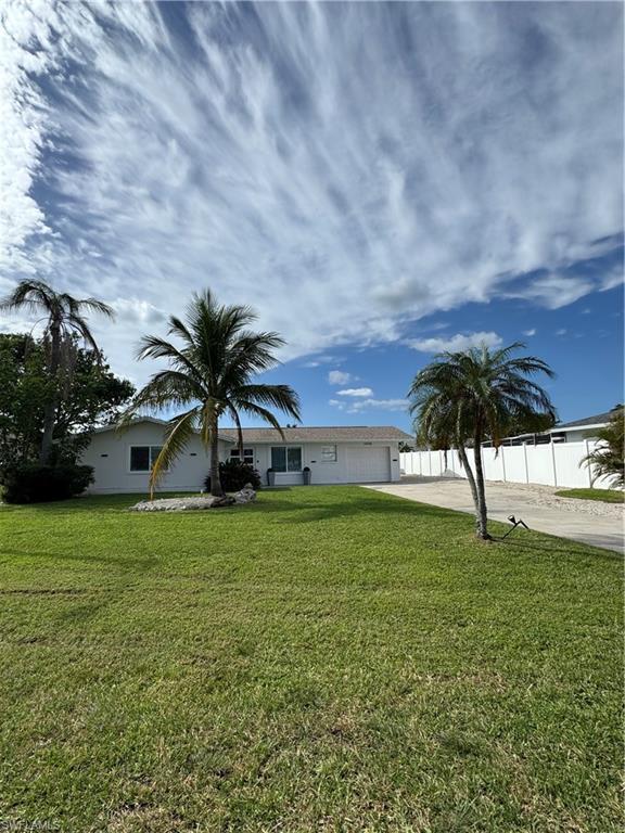 Image 1: Ranch-style house with concrete driveway