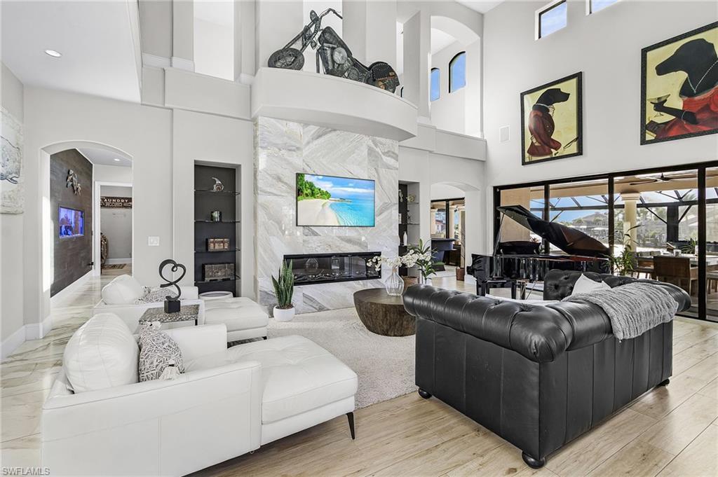 Image 2: Mediterranean / spanish-style house with a standing seam roof, decorative driveway, a front yard, and meticulous landscaping