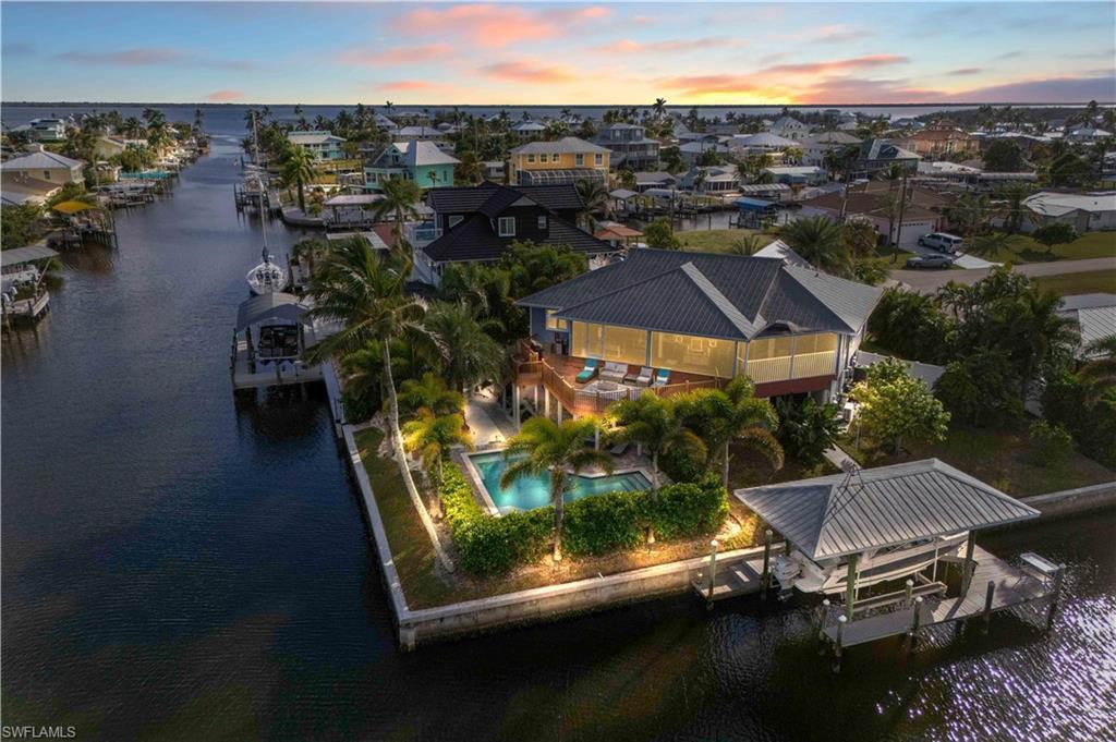 Image 2: Boater&rsquo;s Dream Location! Two minutes to open water with direct Gulf access&mdash;ideal for fishing trips, island hopping, and sunset cruises.  Covered boathouse, resort style backyard!