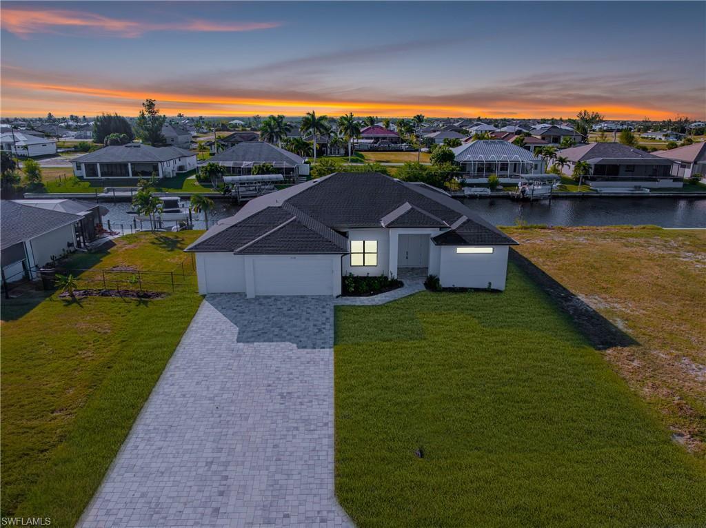 Image 3: Aerial perspective of suburban area featuring a large body of water