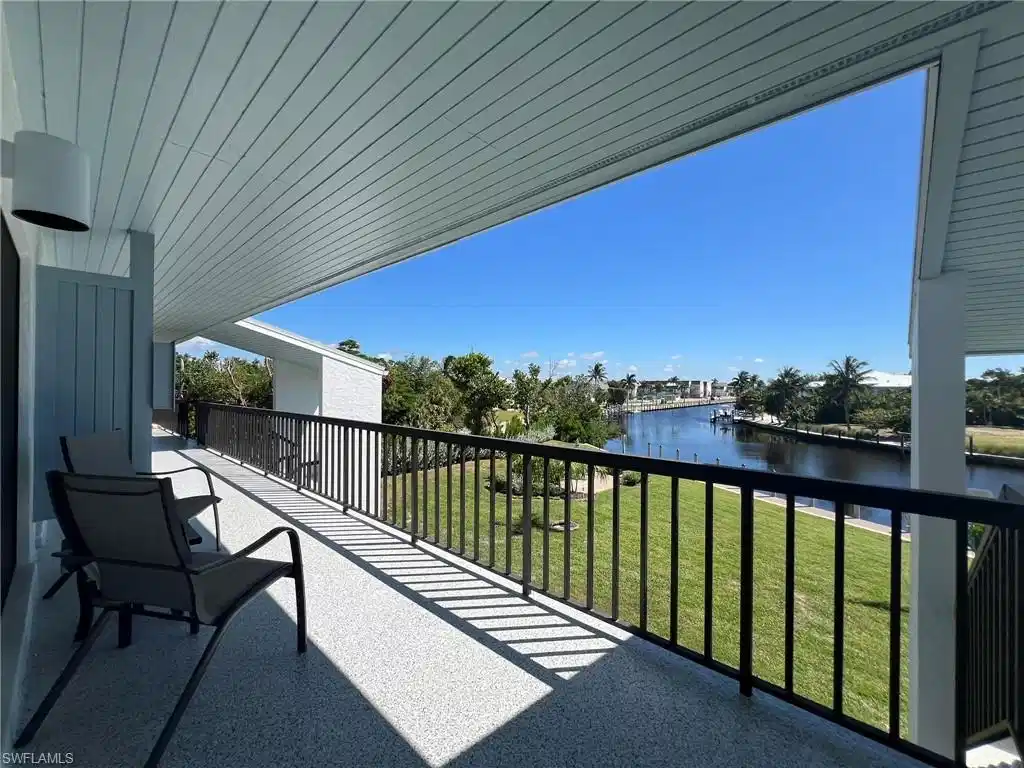 Image 1: Balcony featuring a water view