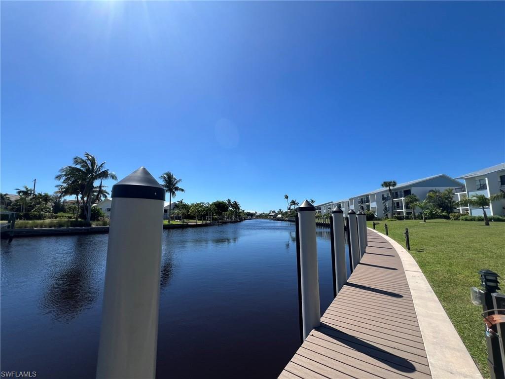 Image 3: Dock with a water view and a yard