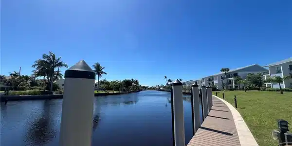 Image 3: Dock with a water view and a yard