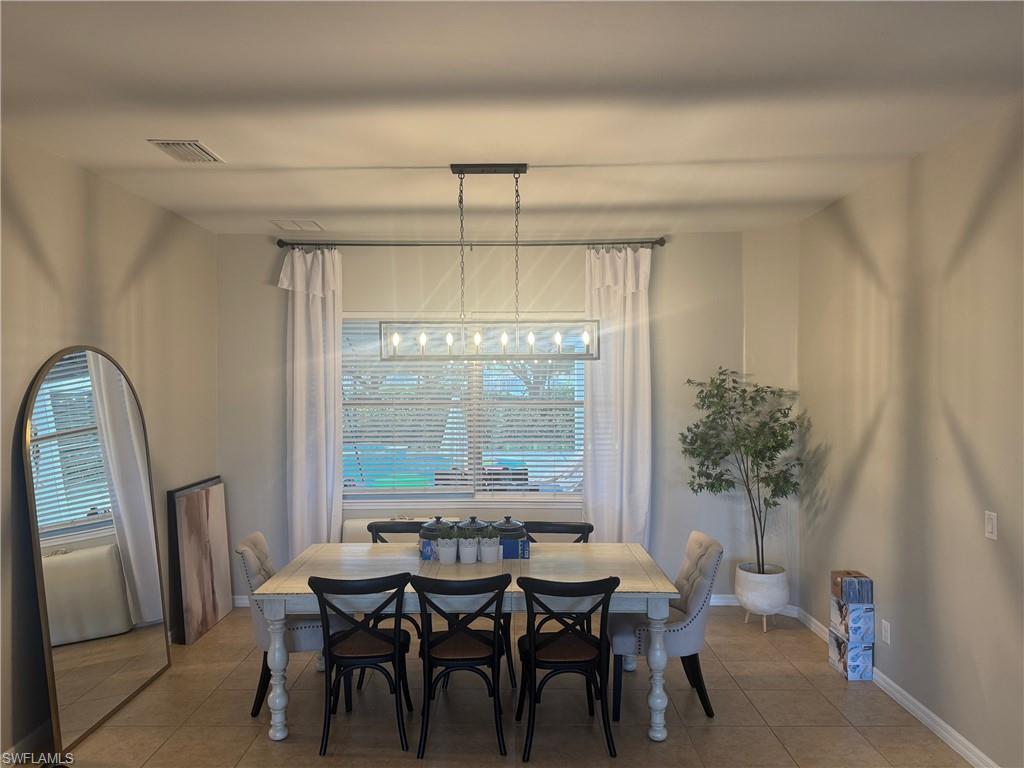 Image 3: Dining space with tile patterned flooring