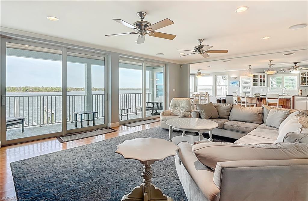 Image 4: Living area featuring plenty of natural light, ornamental molding, ceiling fan, and wood finished floors