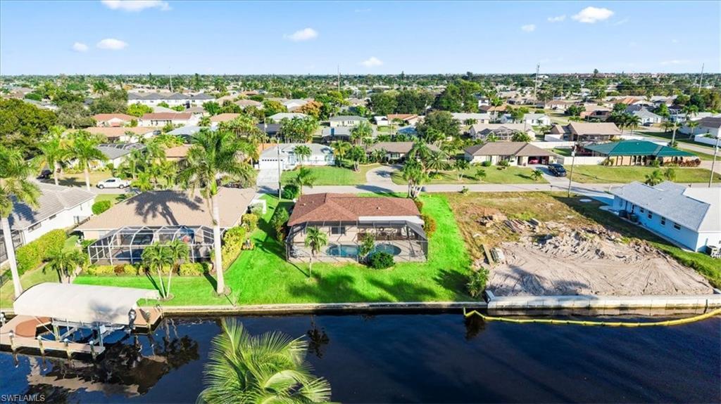 Image 2: Aerial perspective of suburban area with a nearby body of water