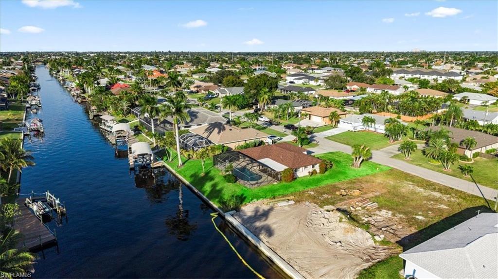Image 3: Aerial view of property and surrounding area featuring a large body of water and nearby suburban area