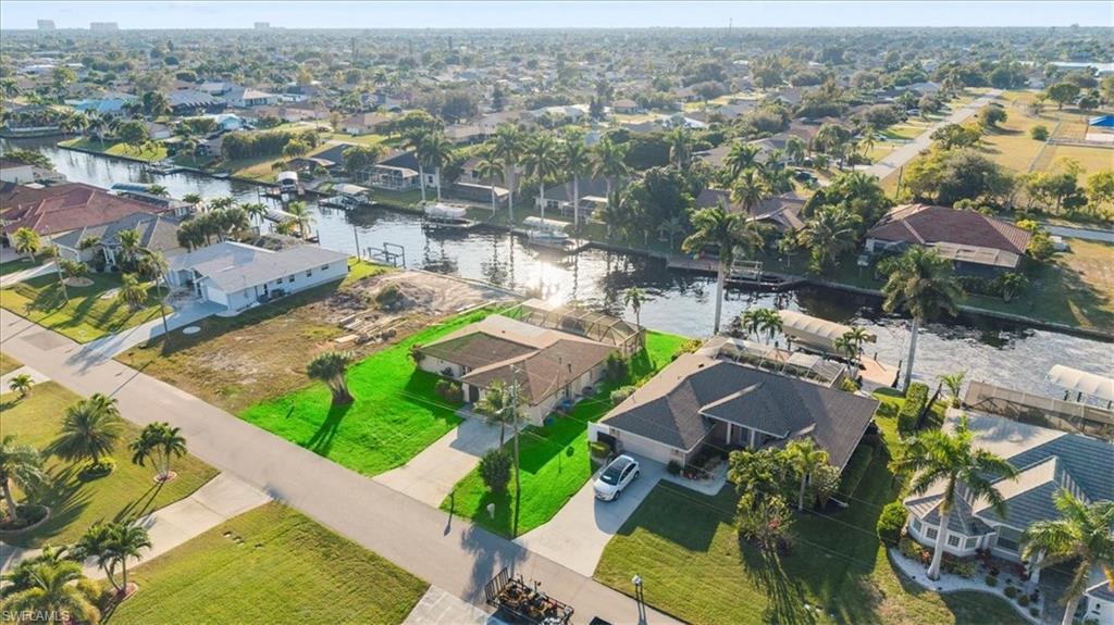 Image 4: Aerial view of residential area with a nearby body of water