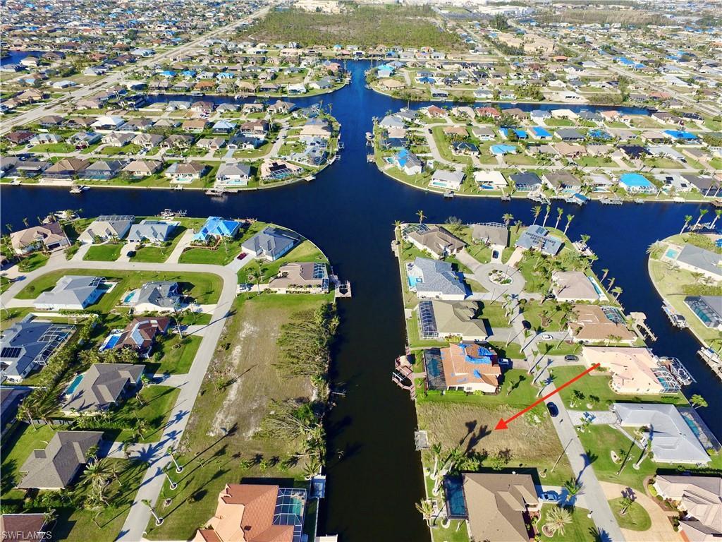 Image 2: Aerial view of property and surrounding area with nearby suburban area and a nearby body of water
