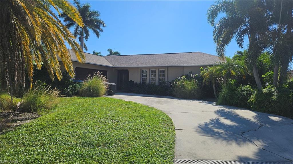 Image 1: Ranch-style home featuring stucco siding, driveway, and a shingled roof