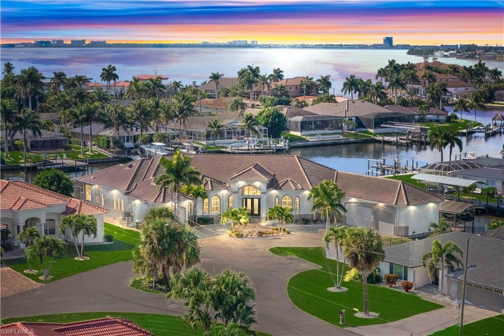 Image 2: Aerial view of residential area with a large body of water