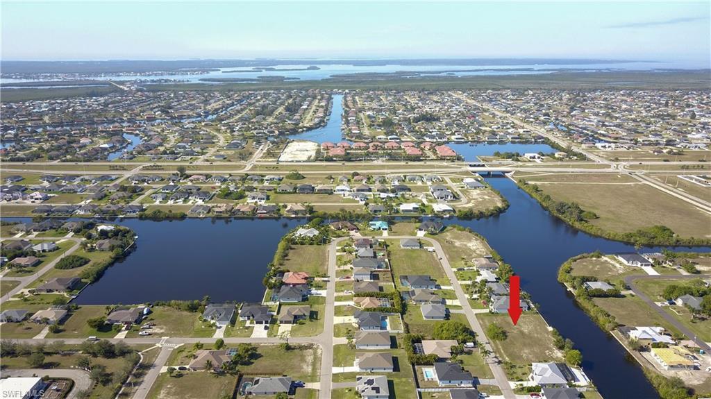Image 2: View of property location featuring a nearby body of water and nearby suburban area