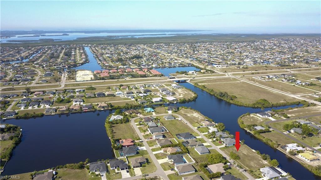 Image 3: Aerial view of property's location featuring nearby suburban area and a large body of water
